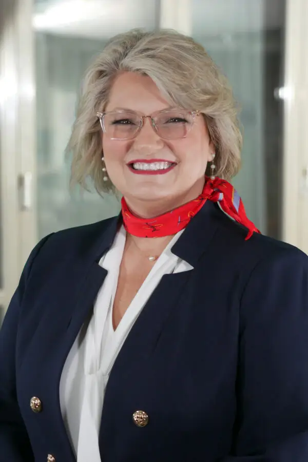 a woman wearing glasses and a red scarf